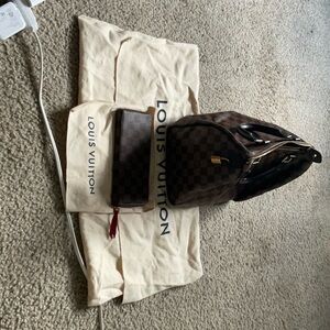 Women Louis Vuitton bag and wallet.